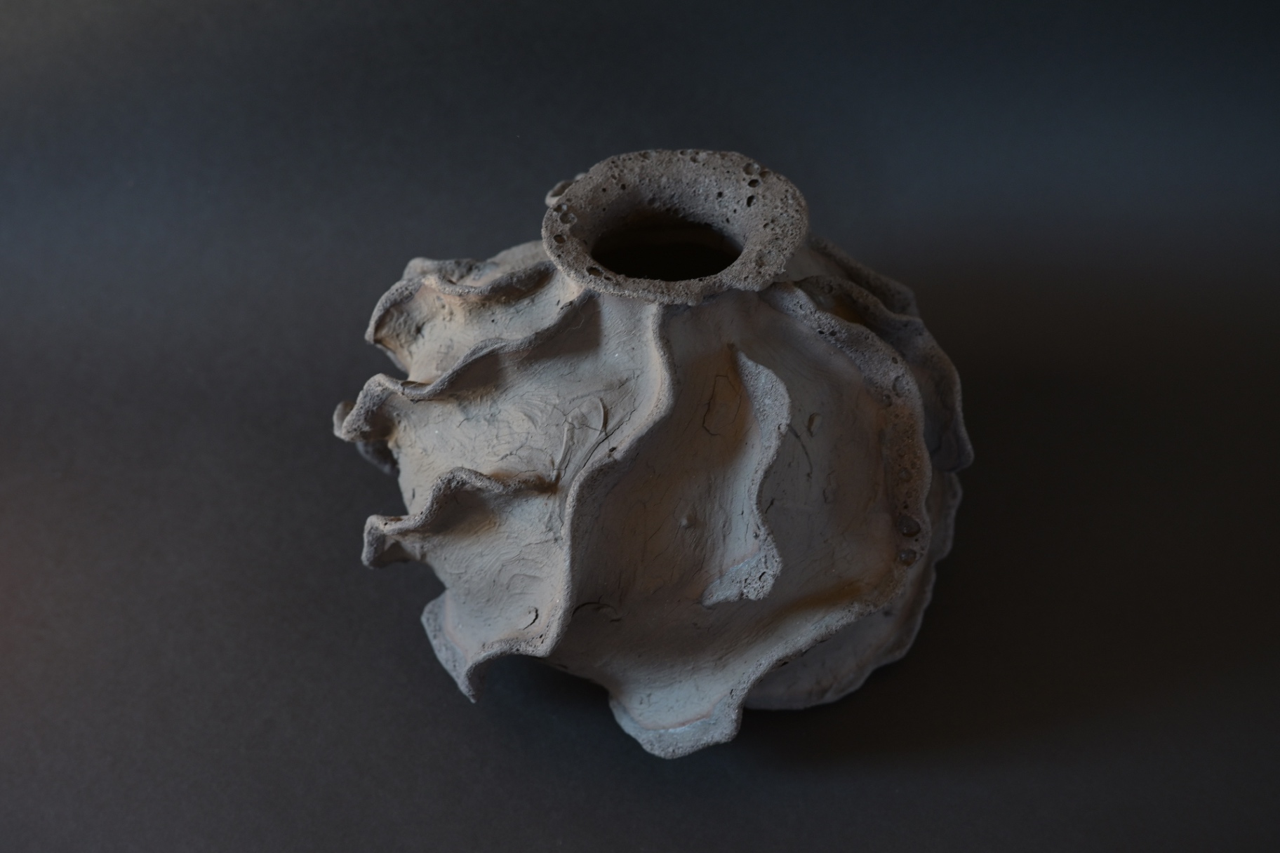 Heat Archive, dark stoneware sculpture with folded ridges surrounding a crater-like opening