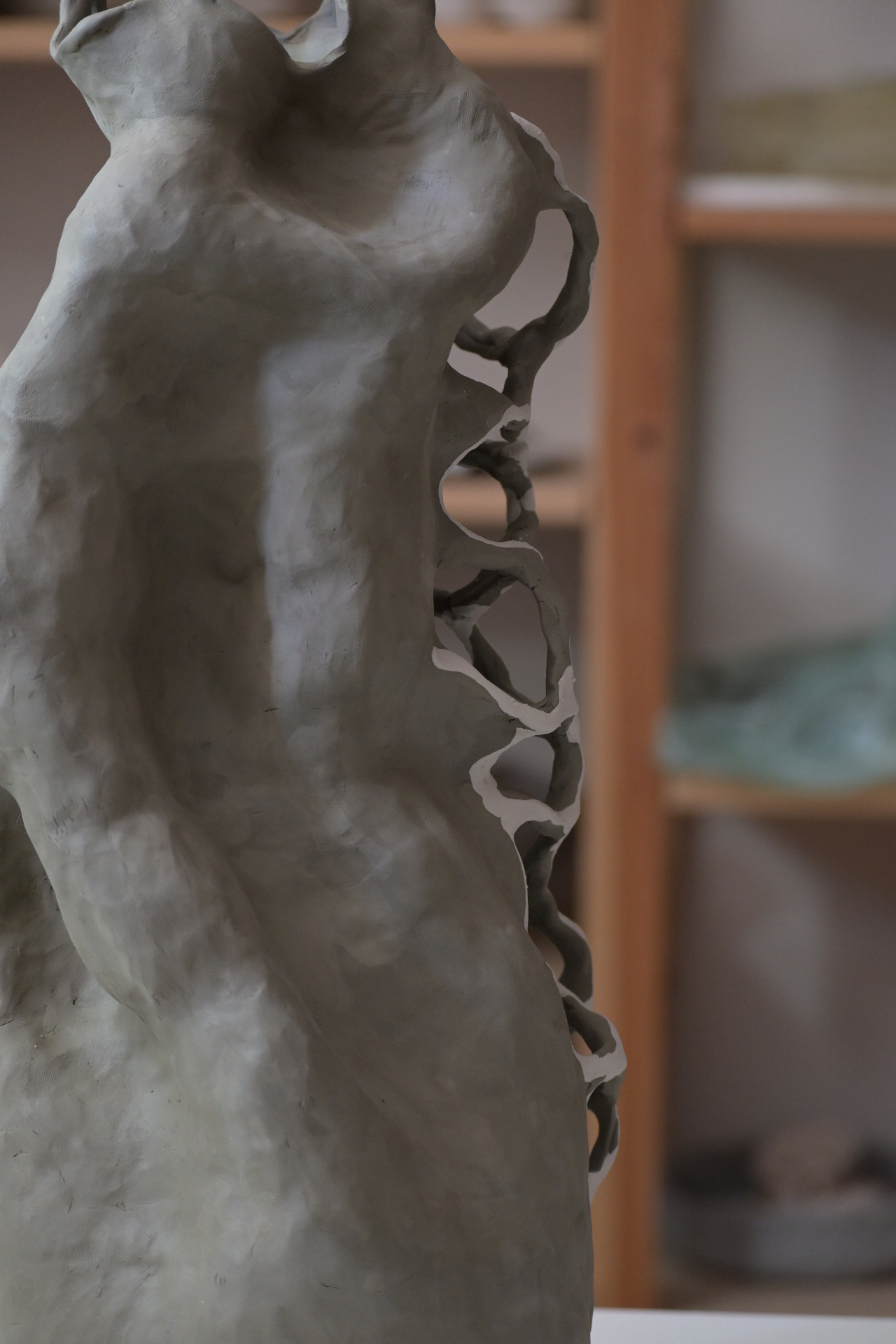 Unfired ceramic form drying in the studio before firing.