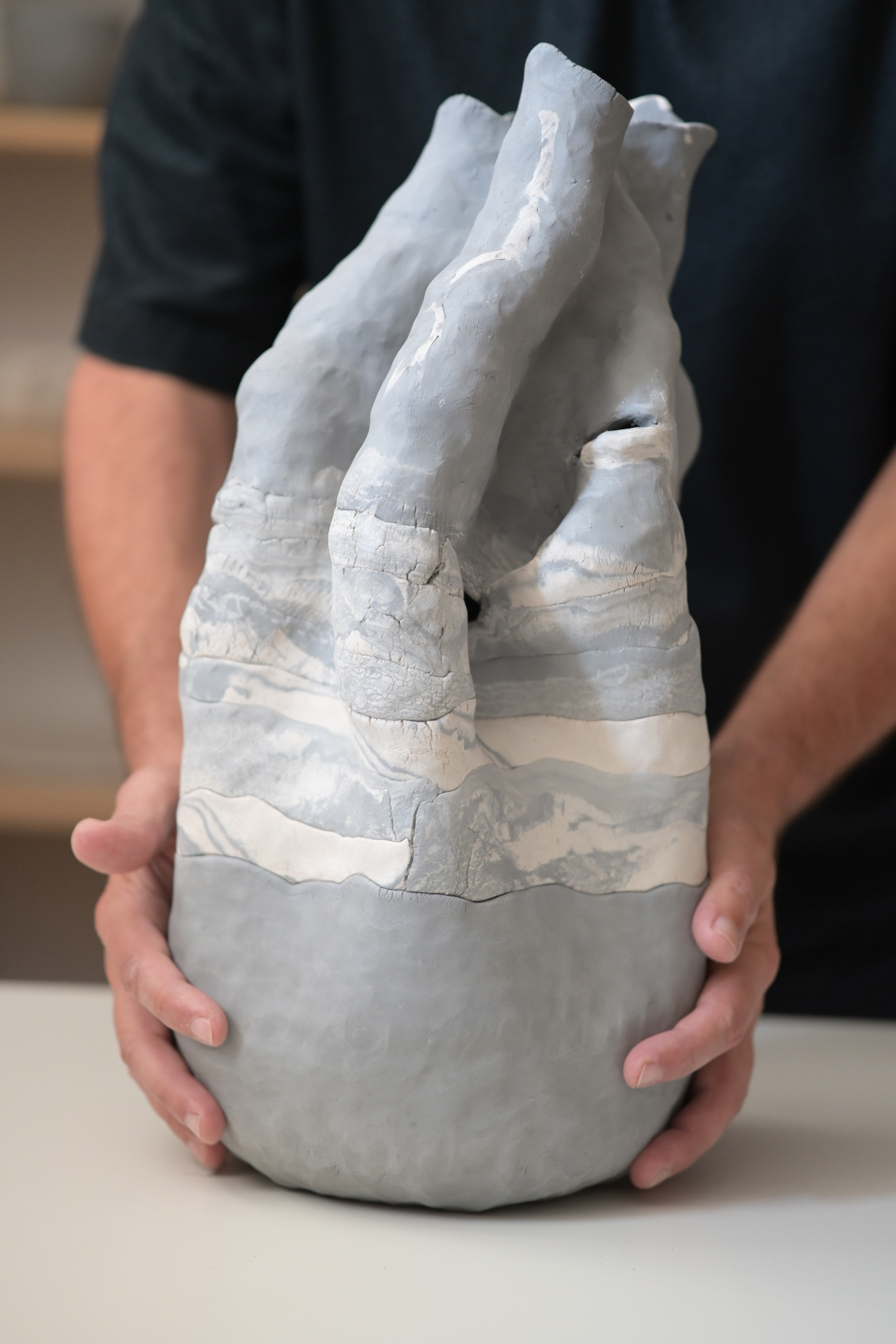 Dacian Morar holding a ceramic work in progress