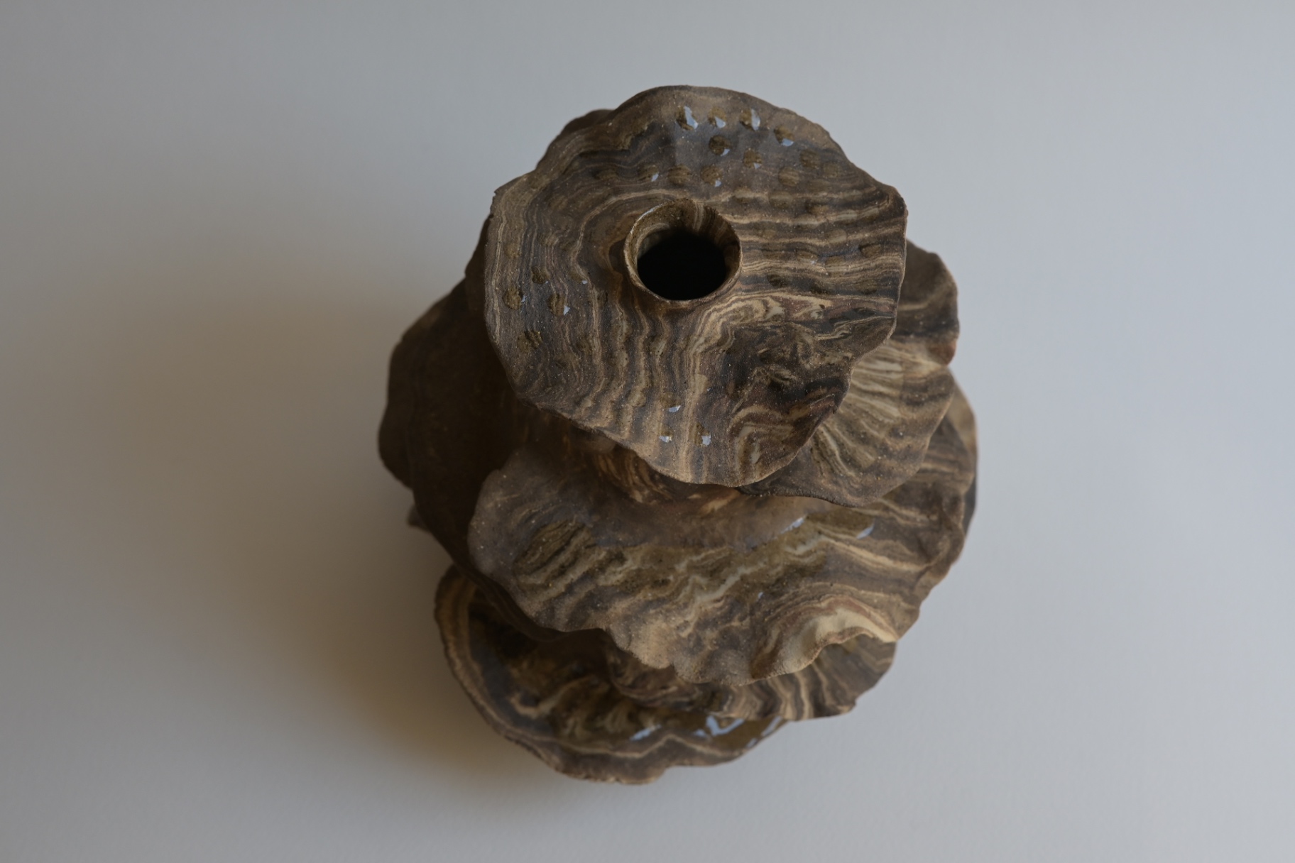 Detail of Where Time Settles showing marbled stoneware layers